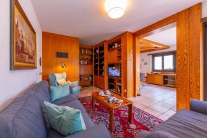 a living room with a couch and a table at Casa Bader in Riva San Vitale