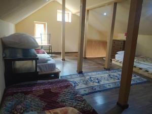 een zolderkamer met een kamer met 2 bedden en een tapijt bij The best view on Tbilisi in Tbilisi City +14 foto's