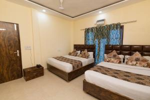 a hotel room with two beds and a window at The Nirvana By Urban Galaxy in Amritsar
