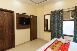 a small room with a bed and a window at The Nirvana By Urban Galaxy in Amritsar