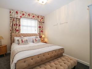 a bedroom with a large bed and a window at The Hideaway in Southsea