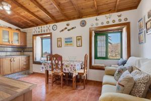 a kitchen and living room with a table and chairs at Rosa del Negro in Alojera