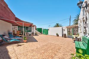 a patio of a house with a building at Rosa del Negro in Alojera