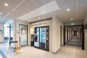a lobby with a drink cooler in a store at B&B HOTEL Troyes Magasins d'usine in Troyes