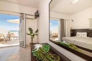 a bedroom with a bed and a view of the ocean at Mouria Studios & Apartments in Laganas