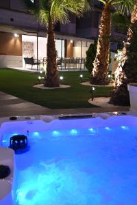 a swimming pool with palm trees in a building at The Royal Garden by LUCIA DE SU in Santa Cruz de Tenerife