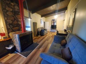 a living room with a blue couch and a fireplace at OMEO Suites Big Bear in Big Bear Lake