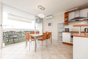 a kitchen and dining room with a table and chairs at Apartment Darko in Split