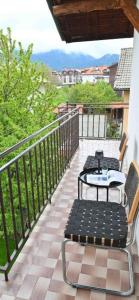 a patio with a table and chairs on a balcony at Discovery Apartment Bansko in Bansko