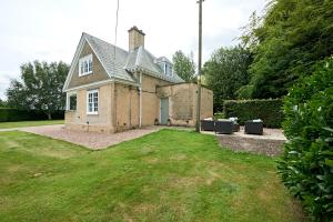 an old brick house with a grass yard at Secluded holiday cottage near the Wolds Way 