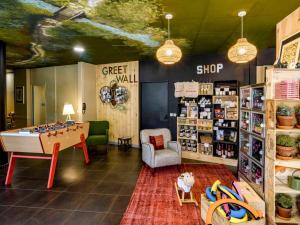 a play room with a table and a shop at Greet Hotel Evreux Centre - Route de Normandie by Accor in Évreux