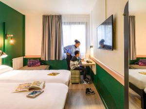 a woman and a child in a hotel room at Greet Hotel Evreux Centre - Route de Normandie by Accor in Évreux