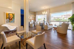 a living room with chairs and a dining room at Best Western Hotel Matisse in Sainte-Maxime