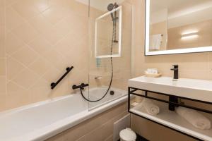 a bathroom with a shower and a tub and a sink at Best Western Hotel Matisse in Sainte-Maxime