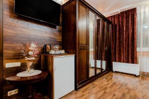 a kitchen with a refrigerator and a table in a room at Poznyakoff Aparthotel in Kyiv
