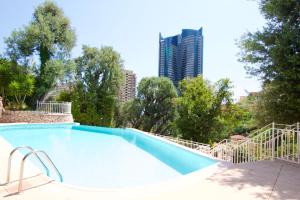 a large swimming pool with a tall building in the background at Sea view Monaco Monte Carlo in Beausoleil