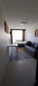 a living room with a couch and a table at Apartamentai PAlanga in Palanga