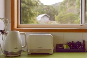 two appliances sitting on a counter next to a window at Little Belmont in Lunawanna