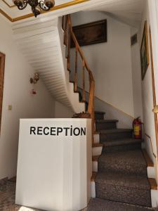a staircase in a house with a sign that reads reception at Kadıköy White House in Istanbul