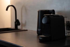 a black toaster sitting on a counter next to a sink at Amata suites in Galissas