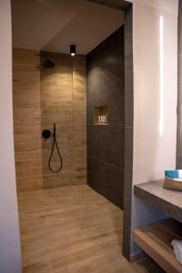 a bathroom with a shower with a glass door at Amata suites in Galissas