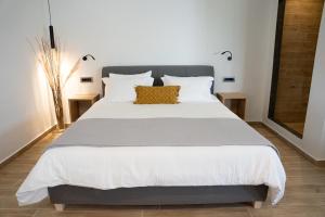 a bedroom with a large bed with white sheets at Amata suites in Galissas
