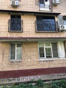 a brick building with windows and balconies on it at Stylish apartments in the heart of the city! in Tashkent