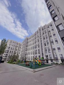a large apartment building with a playground in front of it at RentHouse Apartments Urban Lion in Chişinău