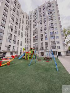 a playground in front of a large building at RentHouse Apartments Urban Lion in Chişinău
