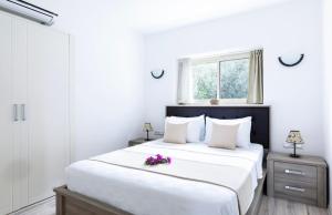 Un dormitorio con una gran cama blanca con flores. en Villa Ruyam en Marmaris