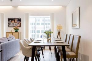 a dining room with a table and chairs at Lovely room in London