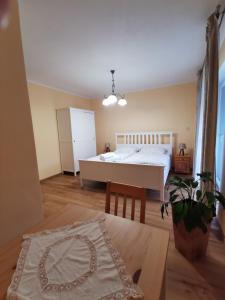 a bedroom with a bed and a table at Apartmán PAWLONIA in Trenčianske Teplice