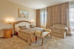 a bedroom with a bed and a chair and a window at Hotel Cvita in Split
