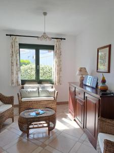 a living room with a couch and a table at Sa Domixedda in Villasimius