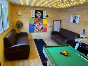 a living room with a pool table and couch at Sunshine Cottage Tideswell, Games room included. in Tideswell