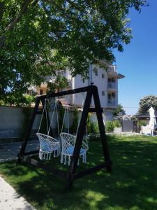 a swing in a yard under a tree at Blue Breeze in Sinemorets