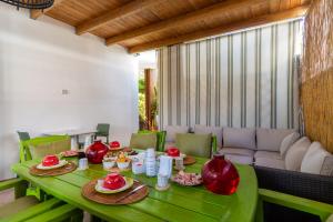 a green table with food on it in a living room at Mini Appartamento verde in Gallipoli
