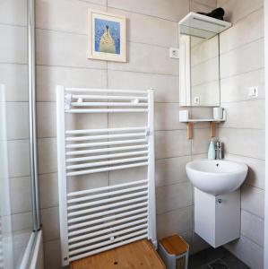 a bathroom with a sink and a toilet and a mirror at Studio CAMINO with parking in Zadar