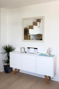 a white dresser with a mirror on a wall at Studio CAMINO with parking in Zadar