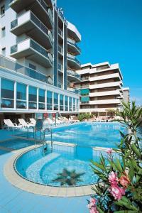 a large swimming pool in front of a building at Hotel Arizona in Riccione