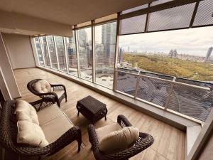 a living room with chairs and a large window at Maslak Aparts in Istanbul
