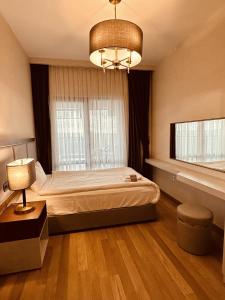 a bedroom with a bed and a chandelier at Maslak Aparts in Istanbul