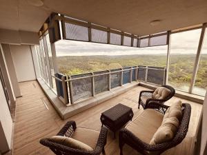 a room with chairs and tables and large windows at Maslak Aparts in Istanbul