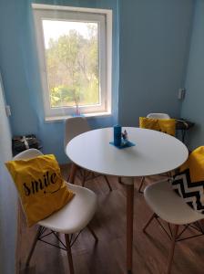 a table and chairs in a room with a window at Bluci seksti in Seksti