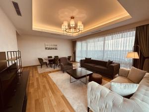 a living room with a couch and a table at Maslak Aparts in Istanbul