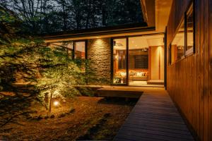 a house with a pathway leading to the front door at La Maison Karuizawa in Karuizawa