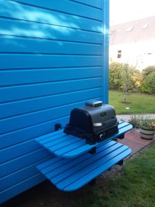 un televisor sentado en un revestimiento azul de una casa en Atlantic Way Shepherd Hut, en Moville