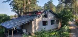 a house with solar panels on the roof at Brīvdienu namiņš in Saulkrasti