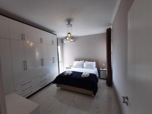 a bedroom with a bed and white cabinets at Arlis House in Golem