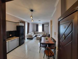a kitchen and a living room with a table and chairs at Arlis House in Golem